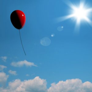 Red Balloon Soaring Representing Freedom Or Being Alone