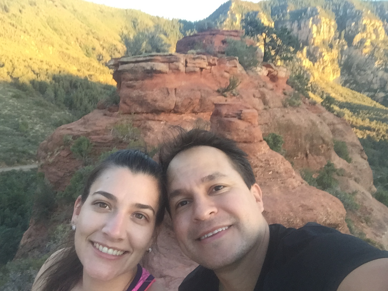 Happy couple taking a selfie in front of Sedona red rock formations after a pre-marital retreat