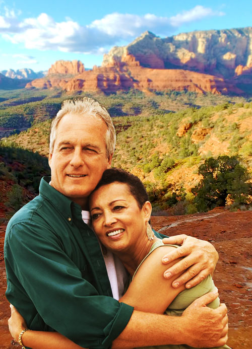 Couple embracing in front of Sedona red rock formations during a couples retreat