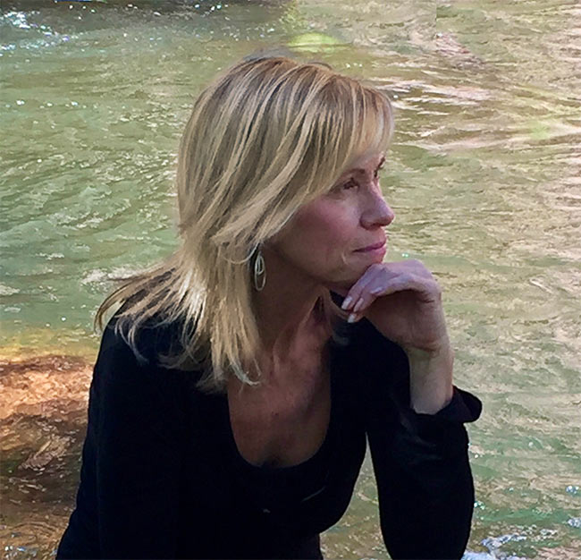 Debra Beck spiritual mentor sitting by creek in Sedona Arizona