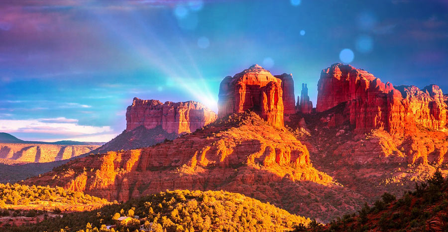 Sedona red rock formations under a vivid purple sky at sunset