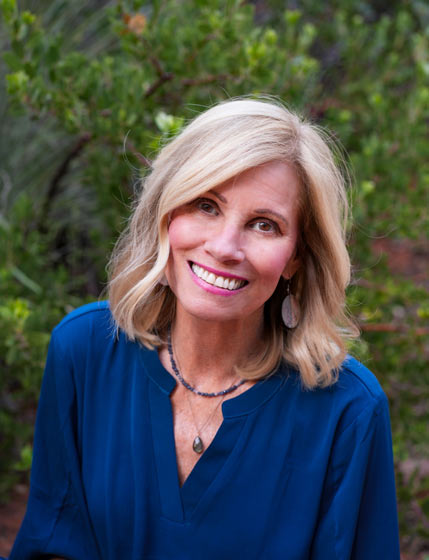 Debra Beck spiritual mentor in Sedona smiling in blue outfit